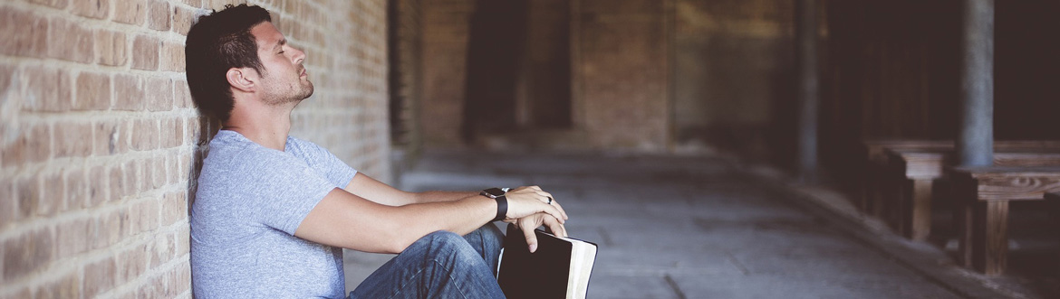 man sat with bible