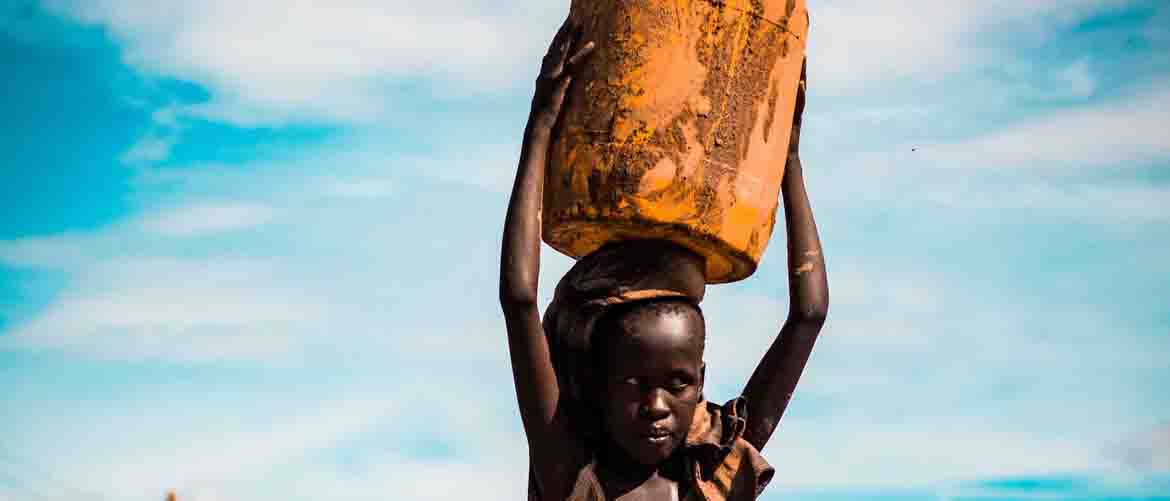 girl carrying can on her head