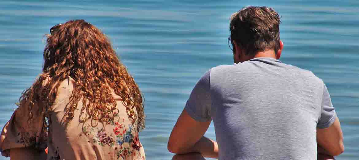 people sat looking out to sea