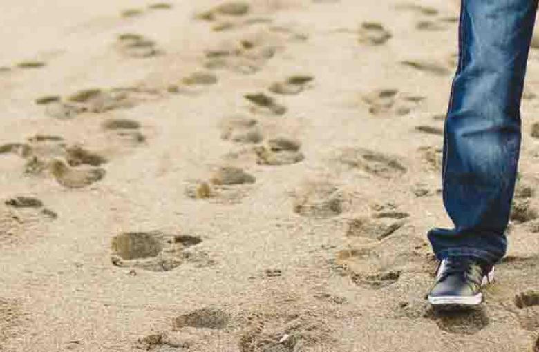 man walking on sand