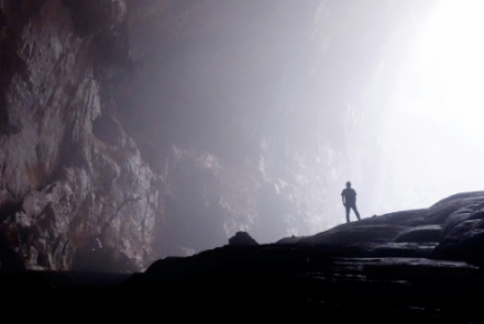 man standing in dark valley